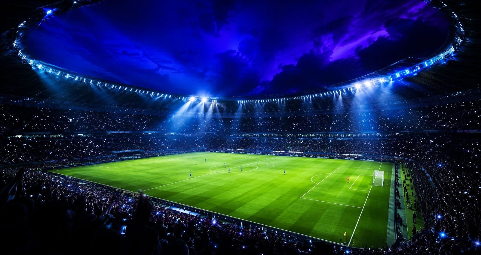 Football stadium at night under brilliant floodlights